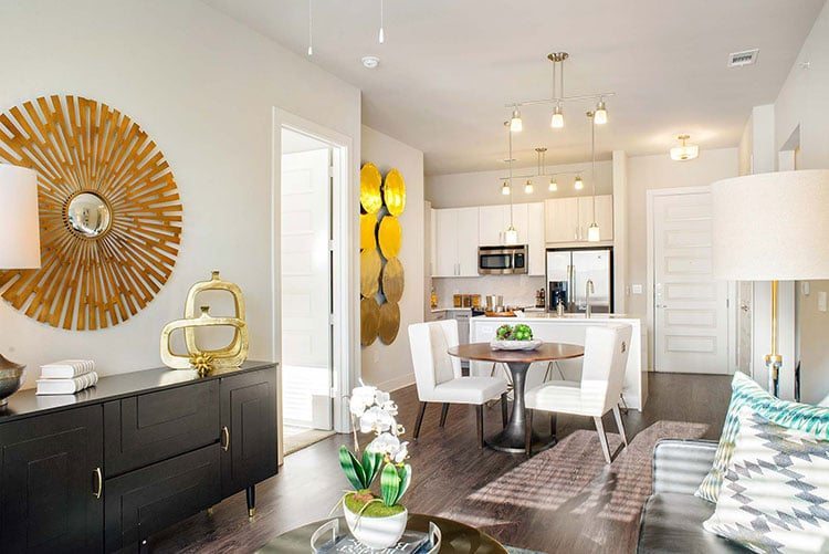 a white modern-designed living room with gold wall decor