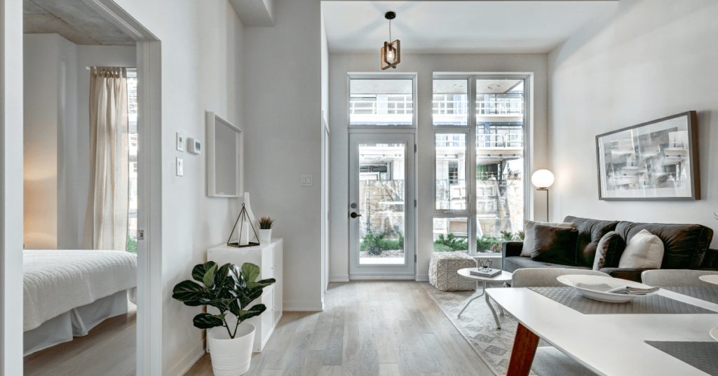 an Apartment with Floor to ceiling Glass Windows and White Walls