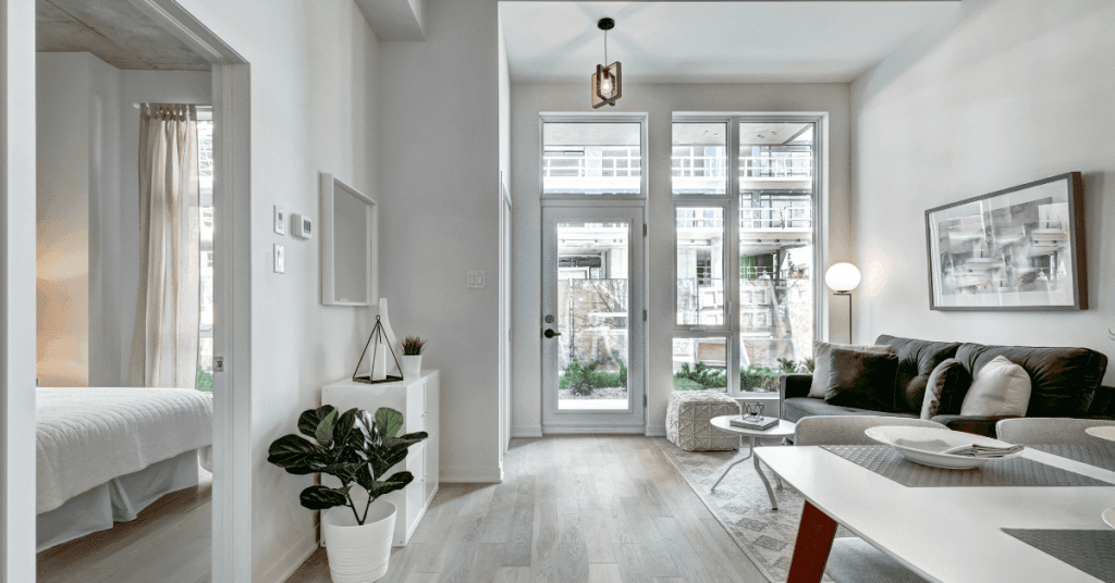An apartment with floor-to-ceiling glass windows and white walls