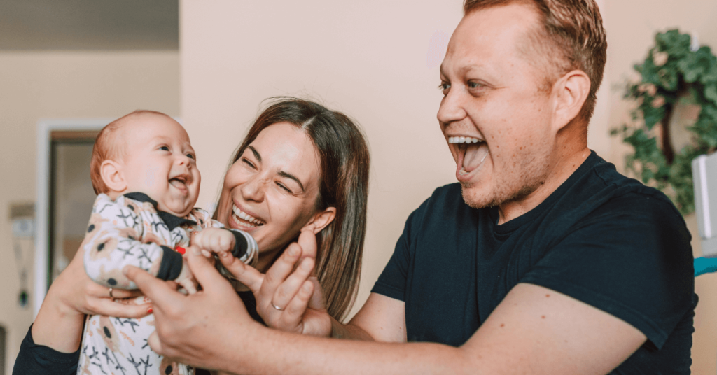 Happy Parents Holding Their Baby in a Houston Apartment