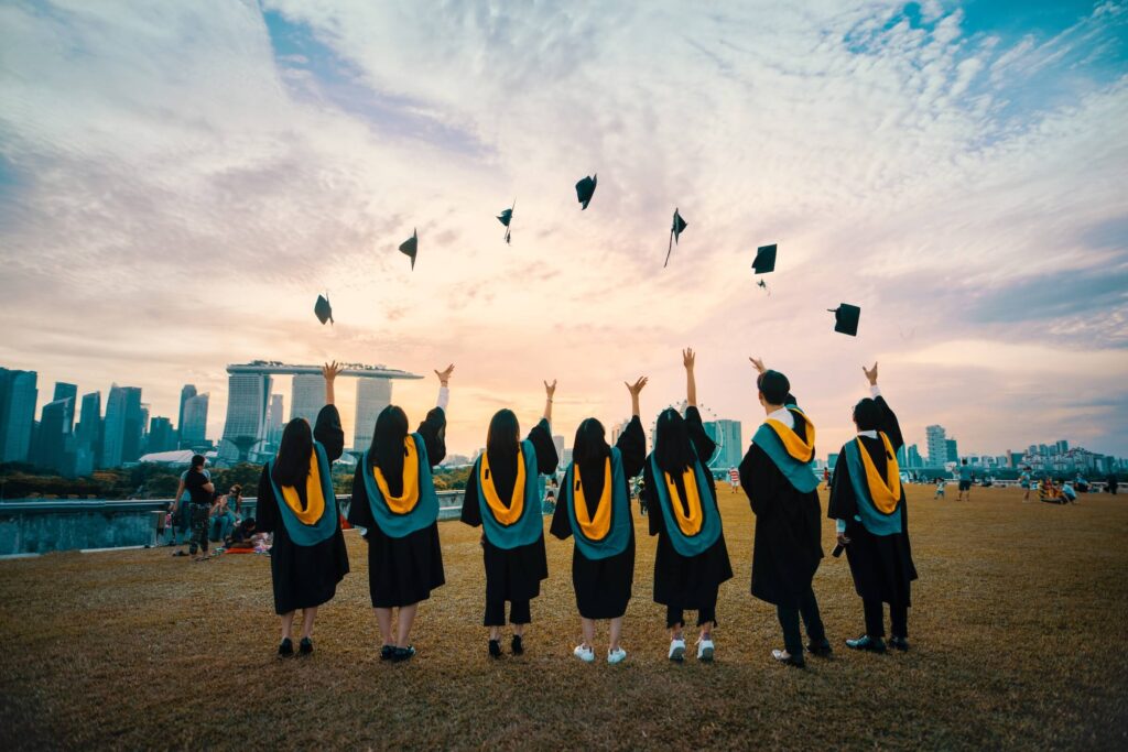 Graduates Wearing Their Gowns and Throwing Their Caps in the Air | Dallas Apartment Locators | Free Service | Call 972 818 3456