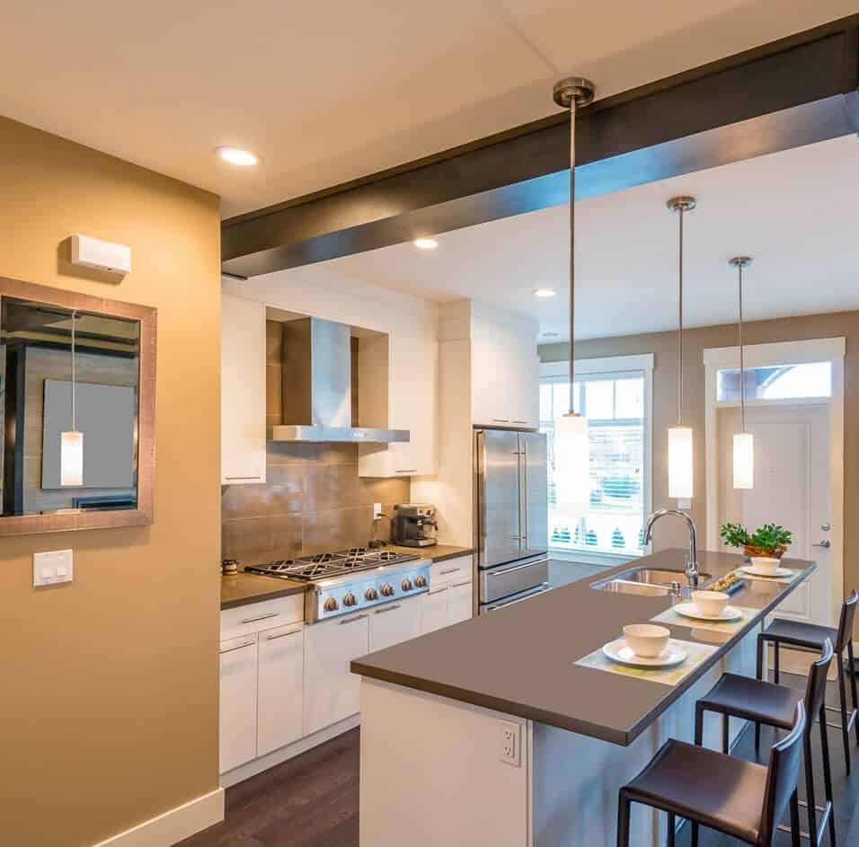 Modern kitchen with island and pendant lighting.