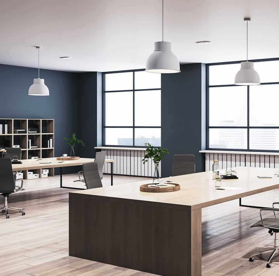 Modern office with large windows and desks.