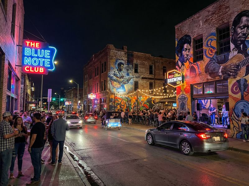 Lively street with neon signs at night