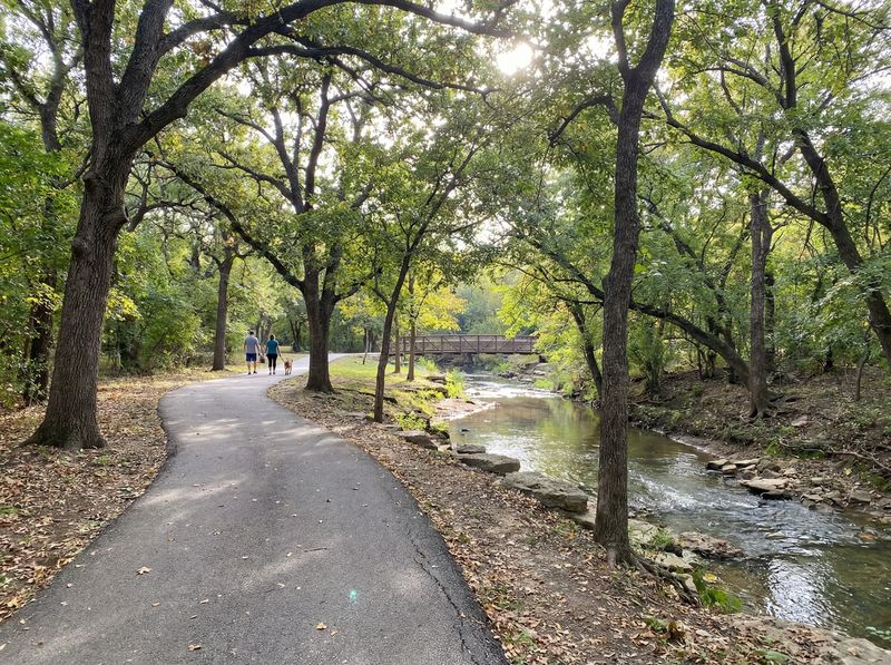 Scenic park path alongside a tranquil stream