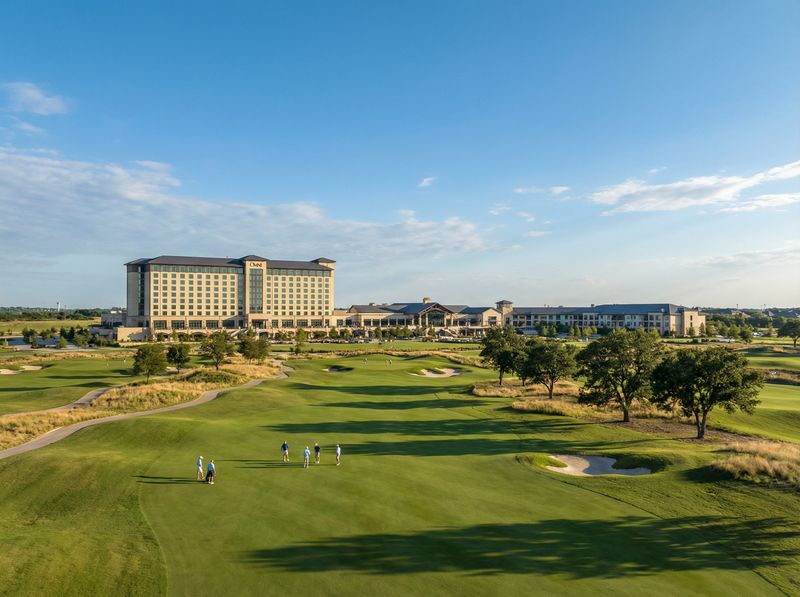 Golf course with large hotel in background