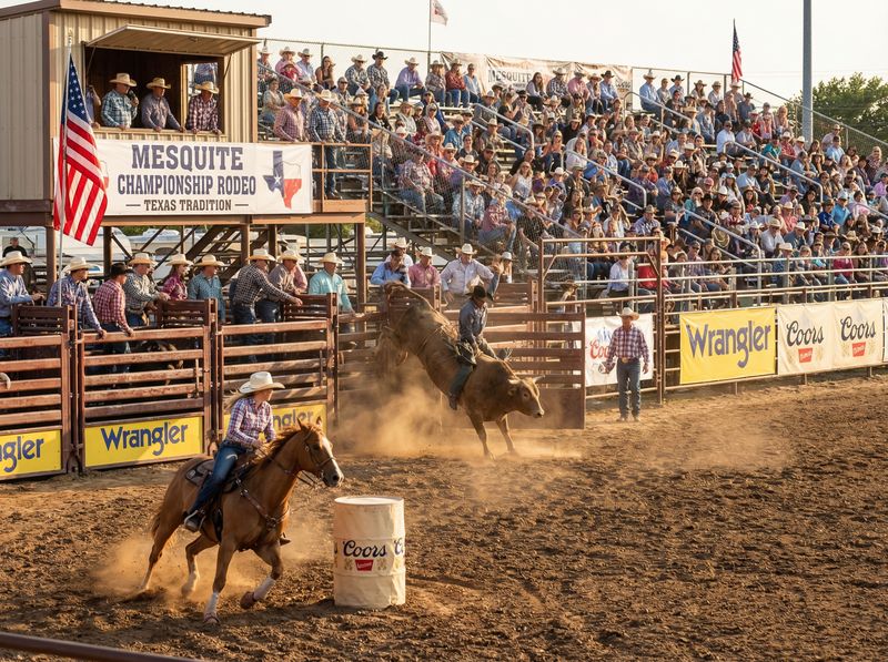 Rodeo event with bull and cowboy in arena.