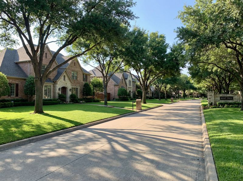 Tree-lined suburban street with brick houses