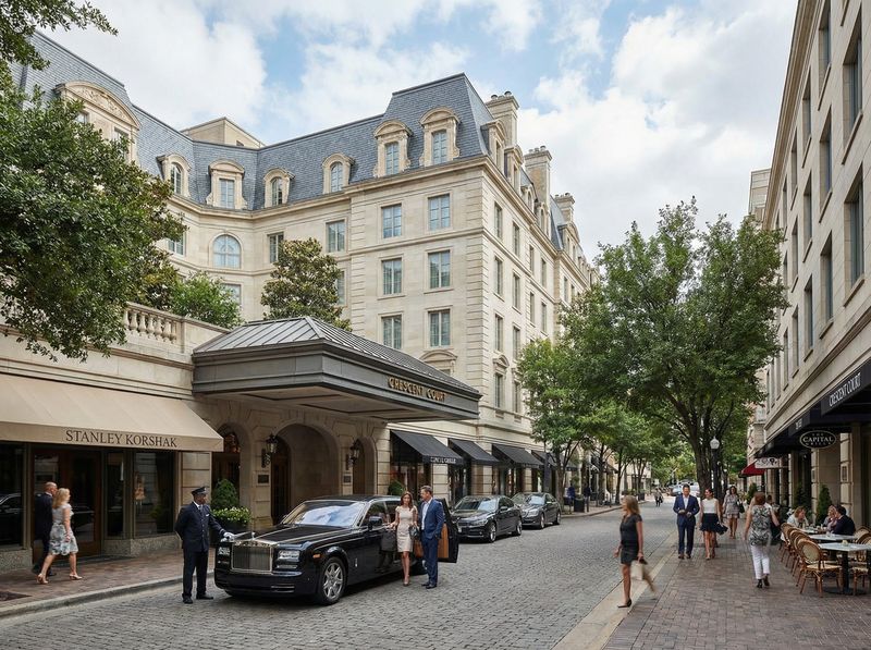 Luxury hotel entrance with parked cars and people
