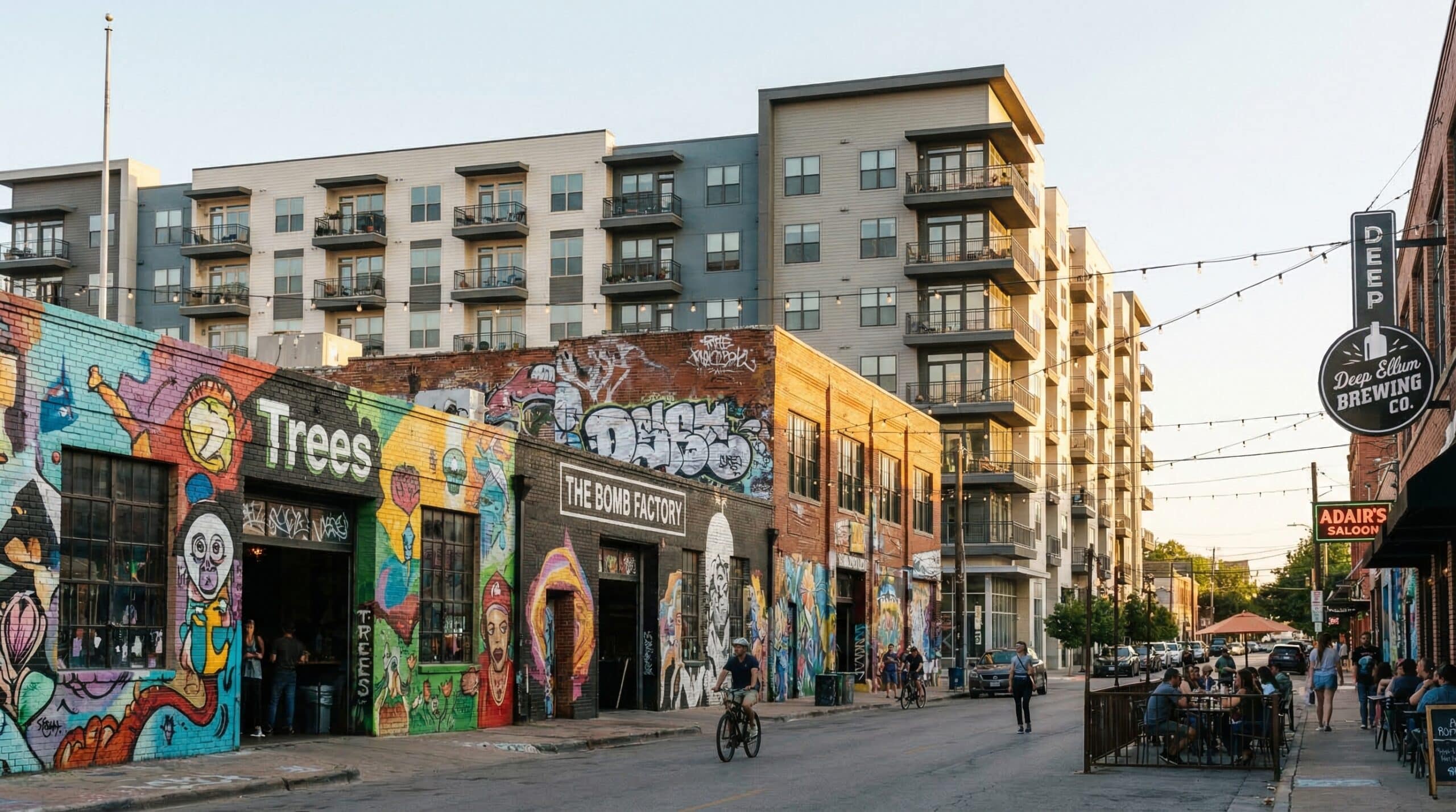 Street with colorful murals and people dining